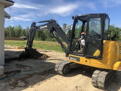 This is an excavator digging out a septic tank system in Cataula, Ga